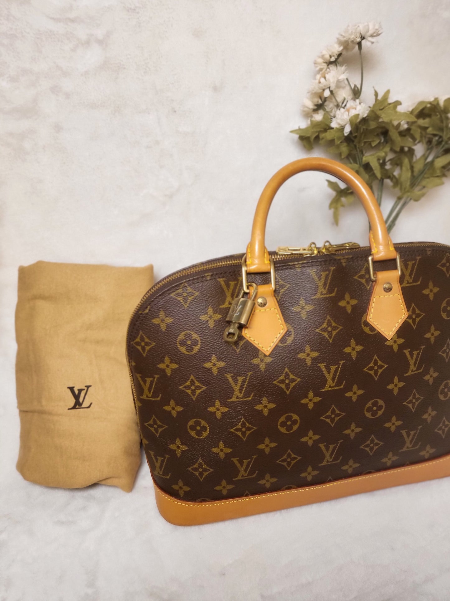 Authentic pre-owned Louis Vuitton Alma pm with lock set