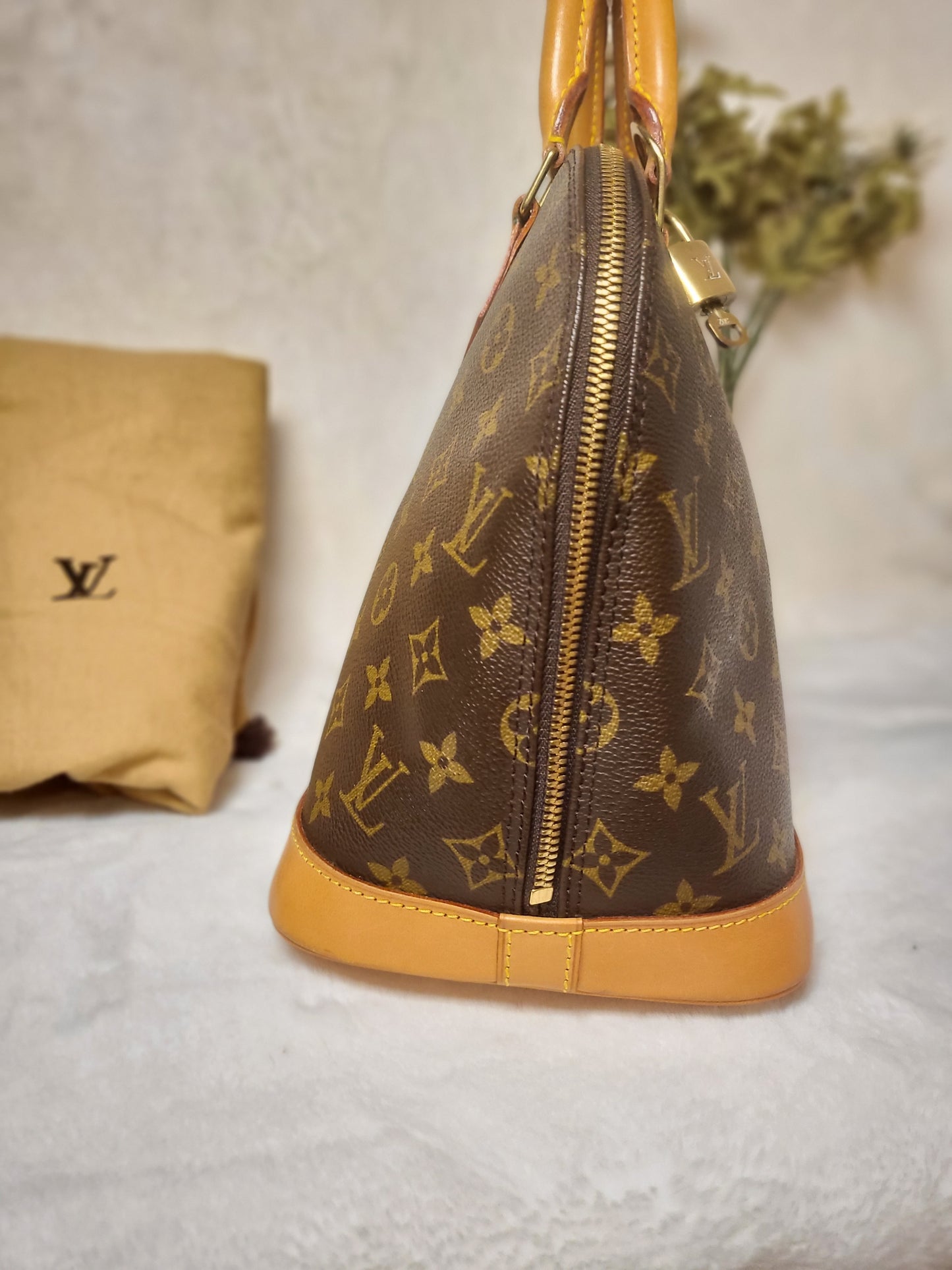 Authentic pre-owned Louis Vuitton Alma pm with lock set